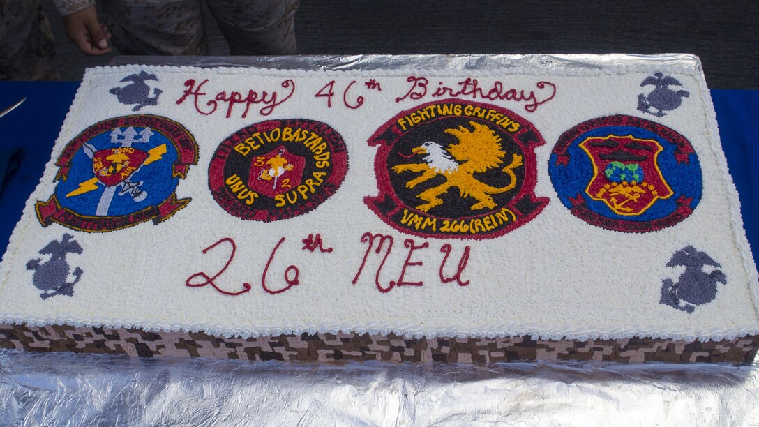 U.S. Marines and Sailors with the 26th Marine Expeditionary Unit stand in formation before a birthday cake cutting ceremony to celebrate the MEU’s 46th birthday aboard the amphibious assault ship USS Kearsarge (LHD 3), April 24, 2013.  Currently deployed to the 5th Fleet Area of Responsibility, the 26th MEU operates continuously across the globe, providing the president and unified combatant commanders with a forward-deployed, sea-based quick reaction force. The MEU is a Marine Air-Ground Task Force capable of conducting amphibious operations, crisis response and limited contingency operations. (U.S. Marine Corps photo by Cpl. Kyle N. Runnels/Released)