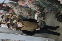 Spouses from various squadrons from Marine Aircraft Group 26 gear up with flak jackets and Kevlar helmets before going to a range aboard Marine Corps Base Camp Lejeune, April 12. Jane Wayne Day gives spouses the opportunity to experience some of the training their Marines go through.