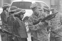 Marines show family members from various squadrons from Marine Aircraft Group 26 the proper procedures of using an M16 A4 rifle before heading out to a range during a Jane Wayne Day aboard Marine Corps Base Camp Lejeune, April 12.   
