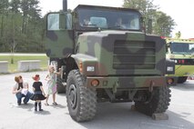 Children climb in to see what a 7-ton truck looks like during the Month of the Military Child during a block party at the Child Development Center aboard Marine Corps Air Station New River, April 13. The Children, Youth and Teen Program hosted the party to inform the children about what their parents do aboard the air station.