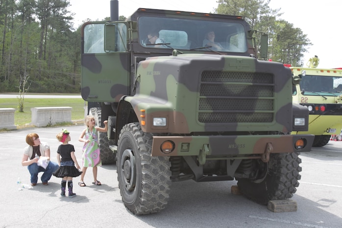 Children climb in to see what a 7-ton truck looks like during the Month of the Military Child during a block party at the Child Development Center aboard Marine Corps Air Station New River, April 13. The Children, Youth and Teen Program hosted the party to inform the children about what their parents do aboard the air station.