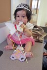 Arianna, 6-month old, chews on a fairy want during the 'Once Upon a Time' story time at the Marine Corps Air Station New River library, April 16. During the story time, children watched as library staff read and re-enacted the story in the book. 