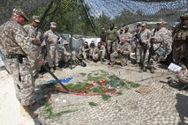 1st Lt. Adam Harris, Left, Marine Wing Support Squadron 272 supply officer, discuses the route and tactics the Marine used during a patrol of the area around the secured landing field during a field training exercise aboard Marine Corps Base Camp Lejeune, April 17. Marines With Marine Wing Support Squadron 272 took to the field to hone the skills learned during Marine Combat Training and to practice airbase ground defense, one of the squadron’s mission essential tasks.