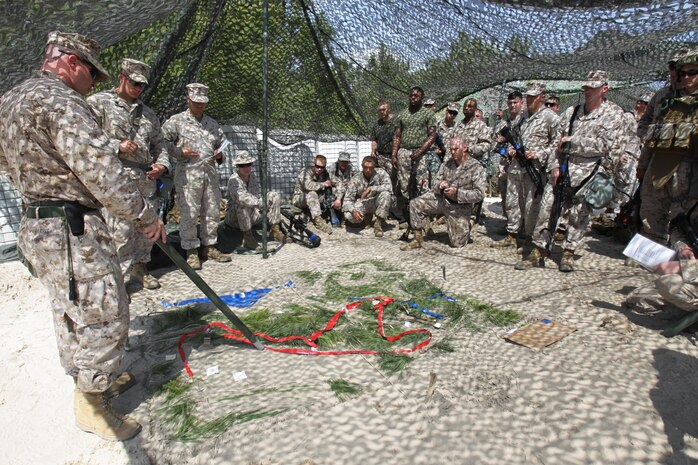 1st Lt. Adam Harris, Left, Marine Wing Support Squadron 272 supply officer, discuses the route and tactics the Marine used during a patrol of the area around the secured landing field during a field training exercise aboard Marine Corps Base Camp Lejeune, April 17. Marines With Marine Wing Support Squadron 272 took to the field to hone the skills learned during Marine Combat Training and to practice airbase ground defense, one of the squadron’s mission essential tasks.