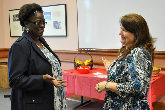 Betty Parker-McCullough (left), Marine Forces Command, speaks with Tammy York, a Marine Corps Systems Command foreign disclosure officer, about how the 2013 Marine Corps Foreign Disclosure Working Group was conducted. MCSC hosted the annual gathering for foreign disclosure officers and personnel who work foreign disclosure issues. The event took place April 16-18 at the Gray Research Center, Quantico, Va. Marine Forces Command will host the event next year. 