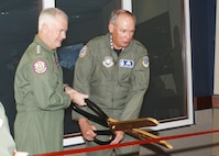 Admiral Keating and General Lord cut the ceremonial ribbon signifying the opening of the "New Command Center" inside the Cheyenne Mountain Operations Center. Photo by Tech. Sgt. Lawrence Holmes 