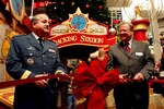 Lt.-Gen. Rick Findley, deputy commander of the North American Aerospace Defense Command, and Robert Taylor, senior property manager at Citadel Mall, perform the ceremonial ribbon cutting during the Nov. 18 launch of the Citadel Mall's Santa Tracking Station. Photo by Tom Kimmell 