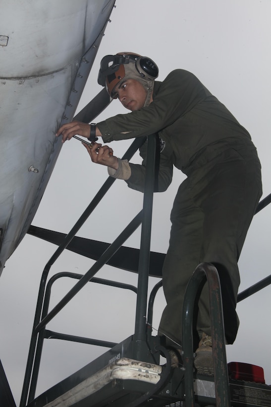 Pfc. Josh N. Villalobos replaces the locking screws of the propeller engine door on a KC-130J Hercules located on the flight line infront of the Marine Aerial Refueler Transport Squadron 252 April 24. Villalobos spends mornings maintaining and fixing anything and everything that has to do with three vital pieces of the aircraft – propellers, engines and fuel lines. He conducts daily checks over all three systems each morning. Villalobos, a Cincinnati, Ohio, native, said the powerline Marines aren’t like other mechanics who deal with the whole aircraft. “Powerline deals with specifics. We have a lot of different moving parts we have to deal with and maintain,” he said. He is a powerline mechanic with VMGR-252.