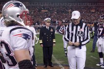 Honorary Denver Broncos Team Captain Adm. Timothy J. Keating, commander of the North American Aerospace Defense Command and U.S. Northern Command; New England Patriot Larry Izzo, left; and Denver Bronco John Lynch prepare for the coin toss by referee Larry Triplette at the Jan. 14 American Football Conference divisional playoff game at Invesco Field at Mile High in Denver. Photo by Spc. Clint Stein 
