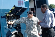 Sgt. 1st Class Munoz of the National Guard’s 8th Weapons of Mass Destruction - Civil Support Team, based at Buckley Air Force Base, Colo., demonstrates the capability of the communications truck at a display of WMD-CST vehicles during the NORAD Chemical, Biological, Radiological, Nuclear conference at Peterson Air Force Base, Colo., Aug. 29-31. The 8th WMD-CST is one of about 40 such teams nationwide that respond to emergencies involving chemical, biological, radiological, nuclear or high explosive agents or substances. Photo by Petty Officer 1st Class Shane Wallenda 