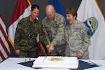 Gen. Gene Renuart, commander of the North American Aerospace Defense Command and U.S. Northern Command, cuts NORAD's birthday cake with Canadian Forces Cpl. Julie Lehoux (left) and Chief Warrant Officer 4 Mary Koepp. Canada and the United States signed the NORAD Agreement May 12, 1958 Photo by Petty Officer 1st Class Joaquin Juatai 