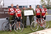 A bicycle team composed primarily of Canadian Forces and American personnel assigned to the North American Aerospace Defense Command and U.S. Northern Command rode 422 miles through the Rocky Mountains in Colorado’s annual Ride the Rockies bike ride in June 2007. The Canadians also raised $4,400 (Canadian) in donations for the "Soldier On" fund supporting injured Canadian military members. Shown here presenting the donation check to NORAD Deputy Commander Lt.-Gen. Rick Findley at NORAD and USNORTHCOM headquarters at Peterson Air Force Base, Colo., are, left to right, Canadian Forces Maj. Don Hilton, Capt. Andrew Hepburn, Findley, Col. André Dupuis, Maj. Dave Rudnicki and Maj. Mike Ashcroft. Not shown are Canadian Forces Maj. Jeff Lebouthillier and Americans Mike Ordonez and Ron Morgan. Photo by Sgt. 1st Class Gail Braymen 