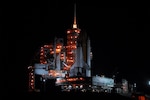 KENNEDY SPACE CENTER, FLA. -- The lighted service structures on Launch Pad 39A cast Space Shuttle Endeavour in shadow after its arrival on Launch Pad 39A after rolling out of the Vehicle Assembly Building. First motion was at 8:10 p.m. July 10 and the shuttle was hard down on the pad at 3:02 a.m. July 11. Endeavour is scheduled to launch on mission STS-118 on Aug. 7. During the mission, Endeavour will carry into orbit the S5 truss, SPACEHAB module and external stowage platform 3. NASA Photo by George Shelton 