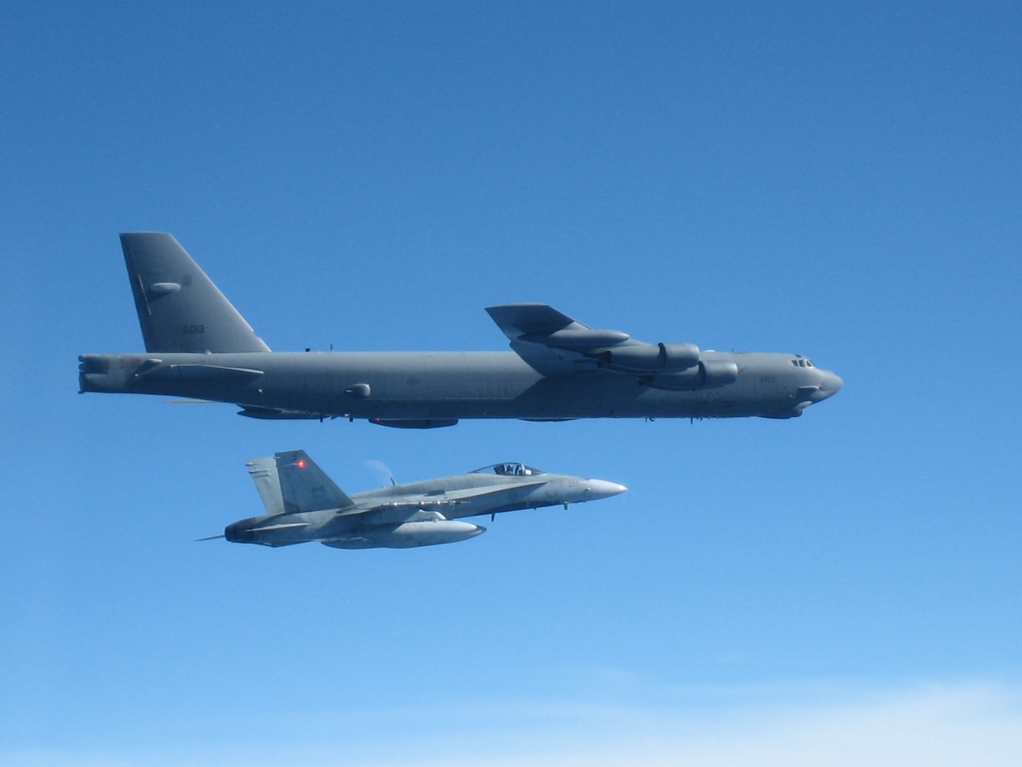 A CF-18 Hornet supporting the Canadian NORAD Region escorts a US Air Force B-52.  The aircraft participated in Exercise Amalgam Dart on September 18, which included aircraft from the Canadian and the Continental US NORAD Regions. Photo by Capt. Corey Mask 
