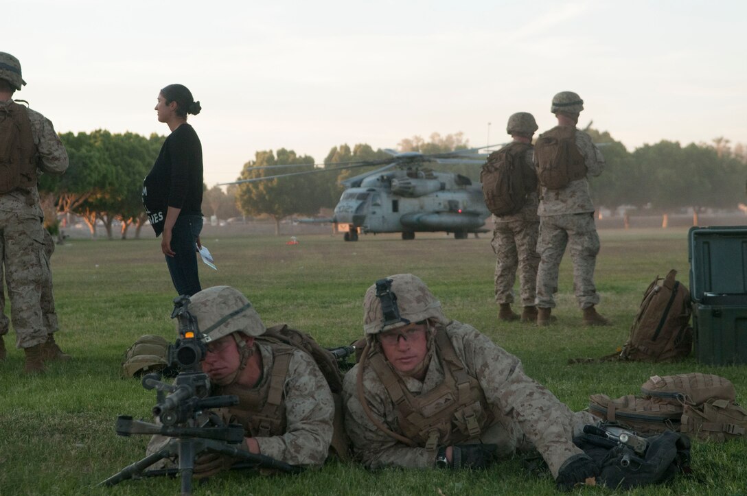 Marine Aviation and Weapons Training Squadron One's Weapons and Tactics Instructor Course 2-13 Marines provide security as CH-53s land and off-load medical personnel and supplies at Kiwanis Park in the city of Yuma, Ariz., April 19. This training evolution was part of a simulated Humanitarian Assistance/Disaster Relief operation which was conducted to test and enhance students' ability to respond quickly to crisis incidents involving displaced civilians.
