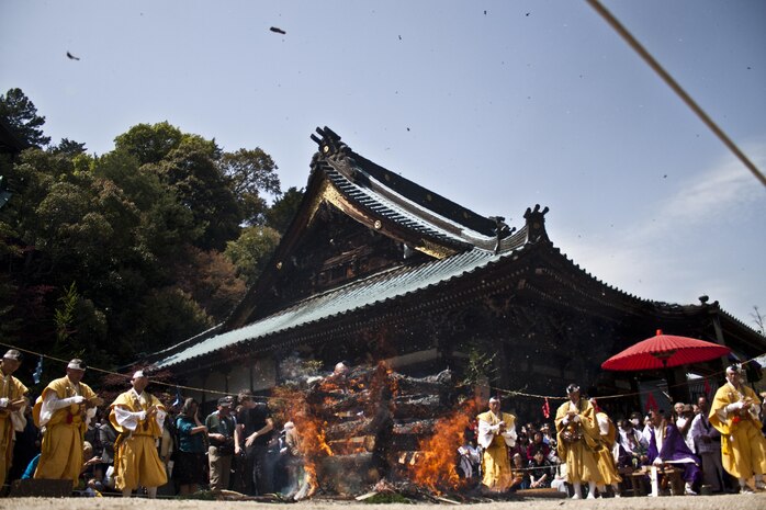 Shingon monks pray around a burning pyre during the Miyajima Fire Walking ceremony, which took place inside the Daisho-in Temple on the Island of Miyajima, April 15, 2013. The Monks perform the procession to pray for good fortune for all people, crops and to fulfill the worshipper’s wishes.