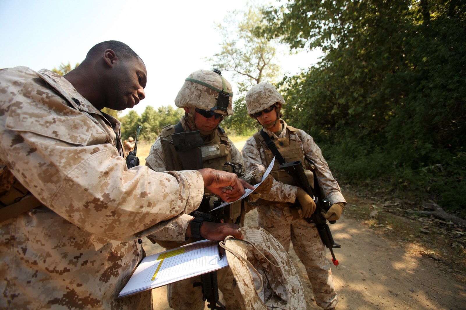 Marines with 1st Maintenance Battalion, 1st Marine Logistics Group, review a map to locate their checkpoint on a patrol during the Basic Combat Skills Course aboard Camp Pendleton, Calif., April 18, 2013. Approximately 40 Marines participated in the course designed to refresh Marines in the basics of Marine Corps combat skills to keep them ready for battle.