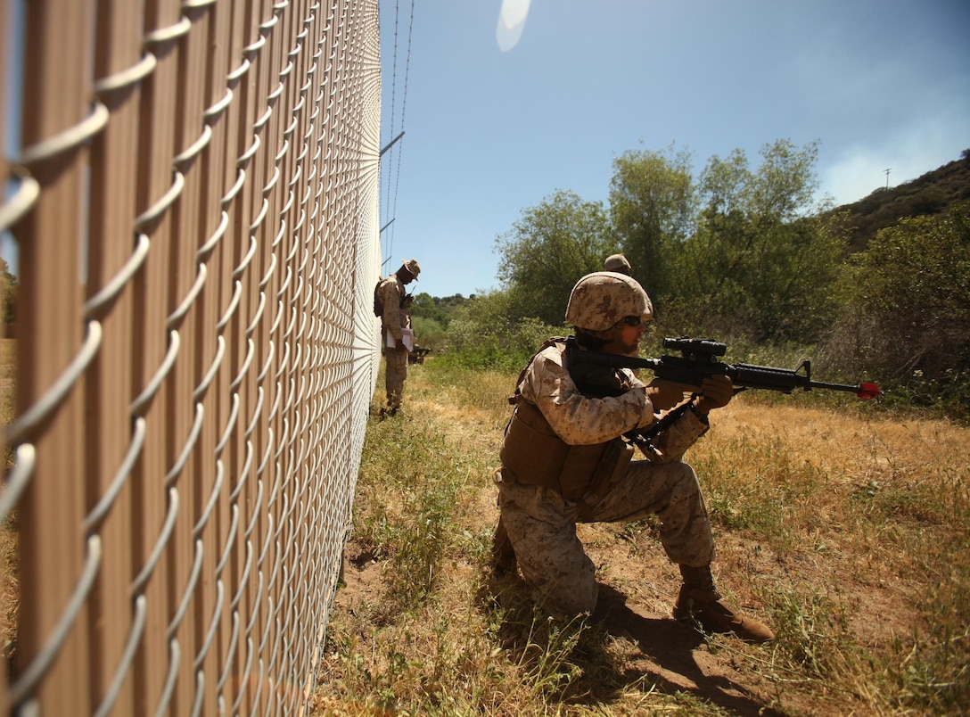 A Marine with 1st Maintenance Battalion, 1st Marine Logistics Group, holds security while on a patrol during the Basic Combat Skills Course aboard Camp Pendleton, Calif., April 18, 2013. Approximately 40 Marines participated in the course designed to refresh Marines in the basics of Marine Corps combat skills to keep them ready for battle.