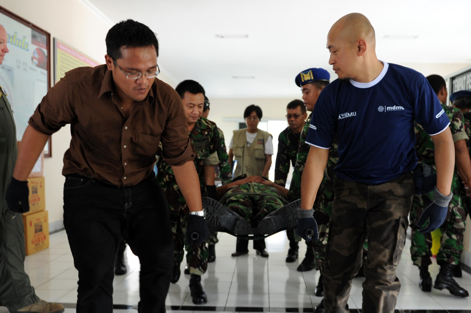 Participants of an aeromedical evacuation subject-matter expert exchange practice lifting a simulated patient on a litter during Pacific Angel 13-2 at Yogyakarta, Indonesia, April 24, 2013. PACANGEL is a joint and combined humanitarian assistance exercise held in various countries several times a year and includes medical, dental, optometry, engineering programs and various subject-matter expert exchanges. (U.S. Air Force photo by Airman 1st Class Kia Atkins)