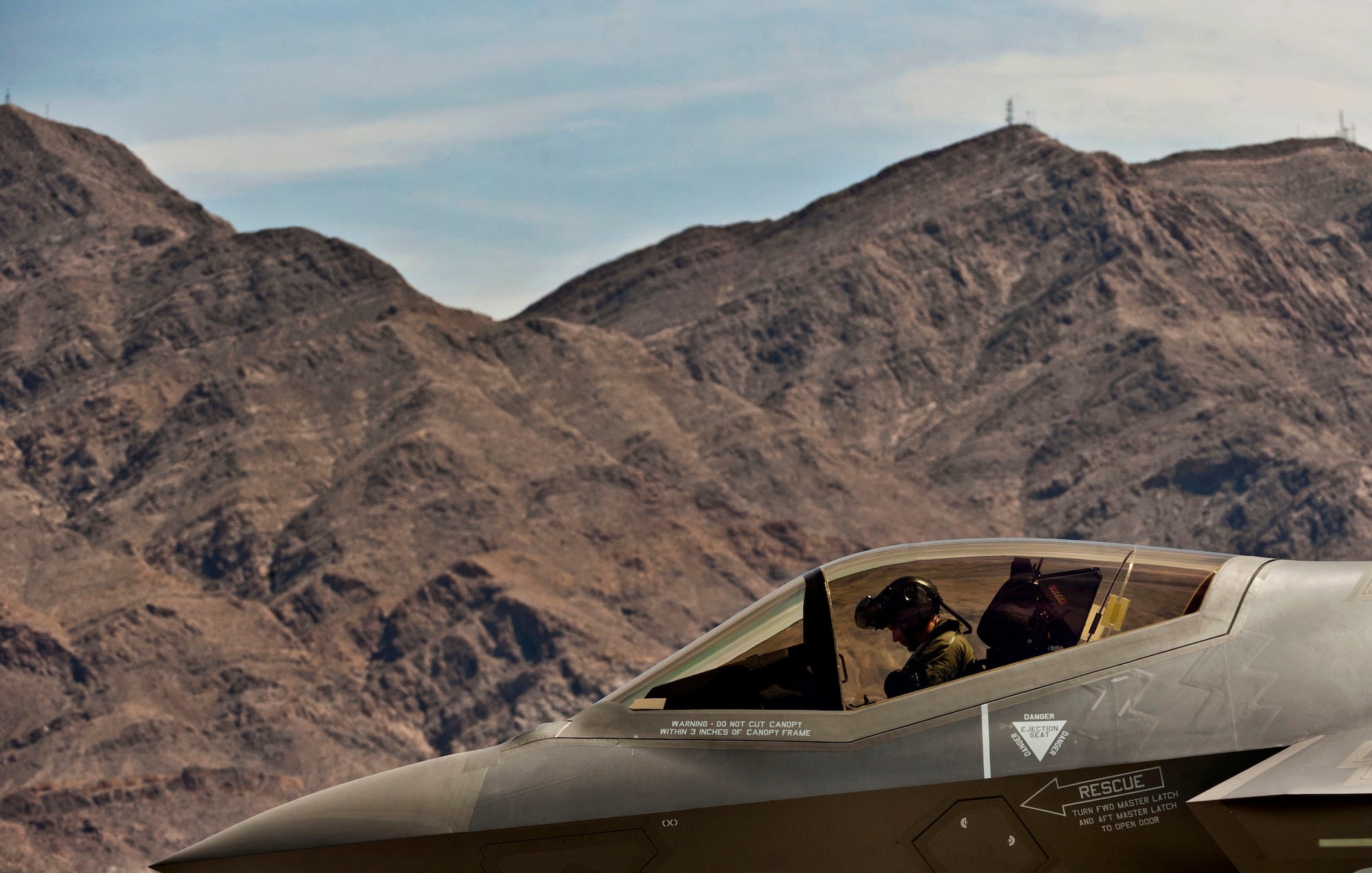 A U.S. Air Force F-35A Lightning II, flown by U.S. Marine Lt. Col. Rodger Hardy with Defense Contract Management Agency, arrives April 24, 2013, at Nellis Air Force Base, Nev. The F-35A Lightning II is a single-seat, single engine, fifth generation, multirole fighter that’s able to perform ground attack, reconnaissance, and air defense missions with stealth capability. (U.S. Air Force photo by Senior Airman Daniel Hughes)