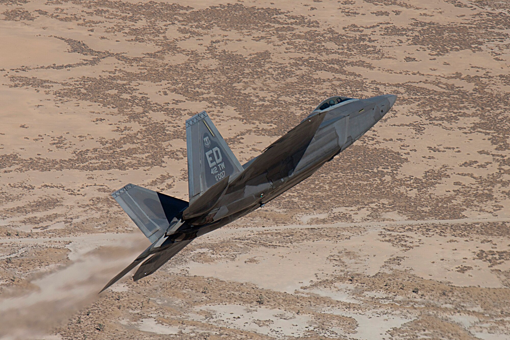 The oldest flying F-22 Raptor, tail number 4007, successfully completed its 1,000th sortie April 19. The F-22 Combined Test Force celebrated the milestone with a James Bond themed plane-side ceremony, referring to the aircraft’s tail number ending in “007.” (Courtesy photo by David Henry/Lockheed Martin)