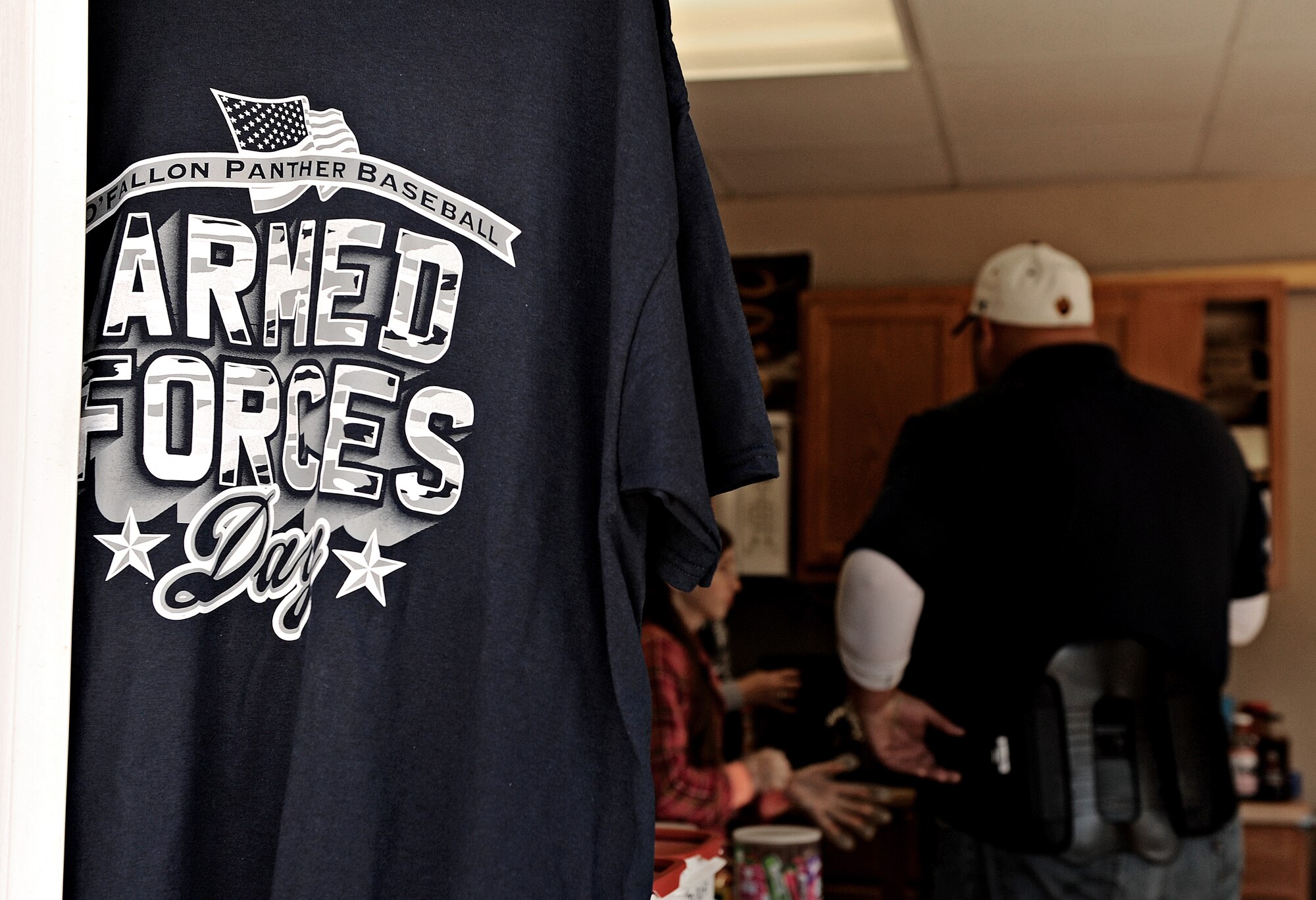 T-Shirts are sold at a concession stand in honor of Armed Forces Day April 20, 2013 in O’Fallon, Ill. Team members of the O’Fallon Township High School varsity baseball team raised money for the Wounded Warriors Project and Hope for Heroes by selling t-shirts and lunch platters. The team also wore desert camouflage jerseys during the baseball game. (U.S. Air Force photo/Airman Kristina Forst)