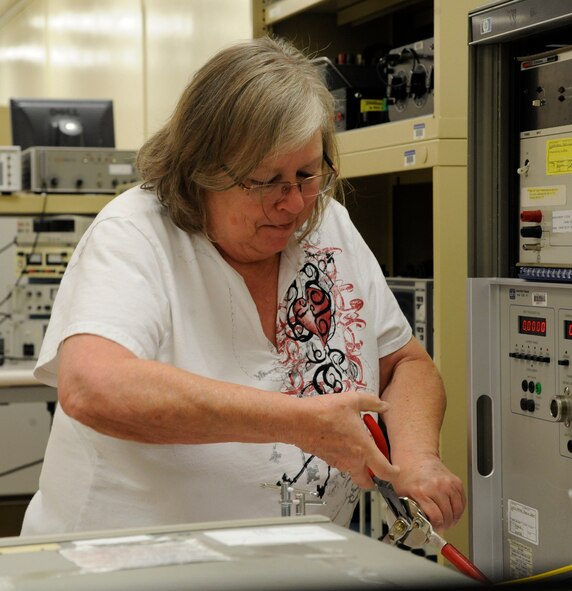 Gwen Acor, Precision Measurement Equipment Laboratory technician, calibrates the amperage on an 8100 transconductance amplifier on Barksdale Air Force Base, La., April 24, 2013. The amplifier is used by the 2nd Maintenance Squadron Non-Destructive Inspection shop during the application of a magnetic particle solution used to fill in and detect cracks in aircraft parts. (U.S. Air Force photo/Airman 1st Class Andrew Moua)