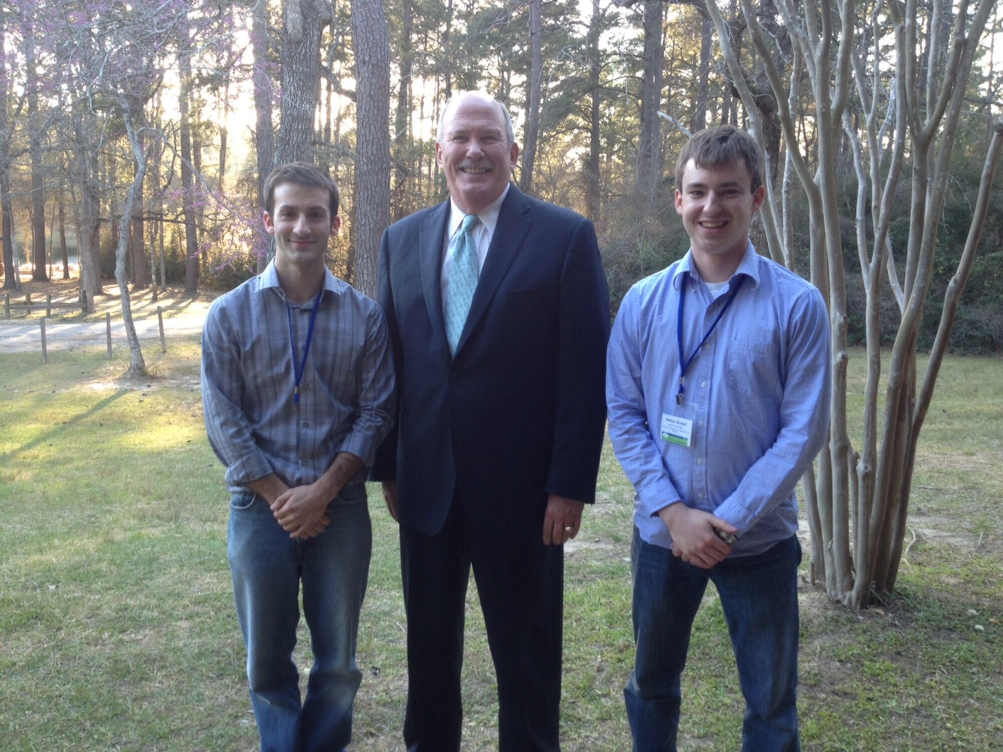 AEDC Engineers Billy Stack, left, and Nathan Sindorf, right, poses for a picture with Jacobs’ President Craig Martin while attending the global Jacobs Future Weekend event in Texas last month. (Photo provided)
