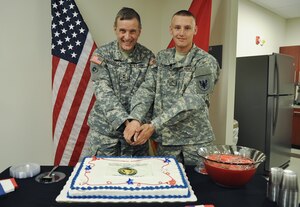 U.S. Army Maj. Gen. Mark MacCarley, Training and Doctrine Command deputy chief of staff, joins Pvt. Justin Thompson, a CH-47 Chinook helicopter maintenance technician currently training at the 128th Aviation Brigade, to ceremonially cut a birthday cake in honor of the U.S. Army Reserve's 105th birthday at TRADOC Headquarters at Fort Eustis, Va., April 23, 2013. Per military tradition, the senior official joins the youngest Service member in garrison to cut the cake. Both Soldiers share service in the Army Reserve: MacCarley began his Army career as a Reserve officer in the Judge Advocate General's corps in 1983; and Thompson is a Reservist assigned to the 90th Aviation Support Battalion in Fort Worth, Texas. The Army Reserve was effectively formed April 23, 1908, when President Theodore Roosevelt signed into public law Senate Bill 1424, creating the Medical Reserve Corps. The corps became the Organized Reserve June 4, 1920, through the National Defense Act Amendments. (Department of Defense photo by Air Force Senior Airman Jason J. Brown/Released)