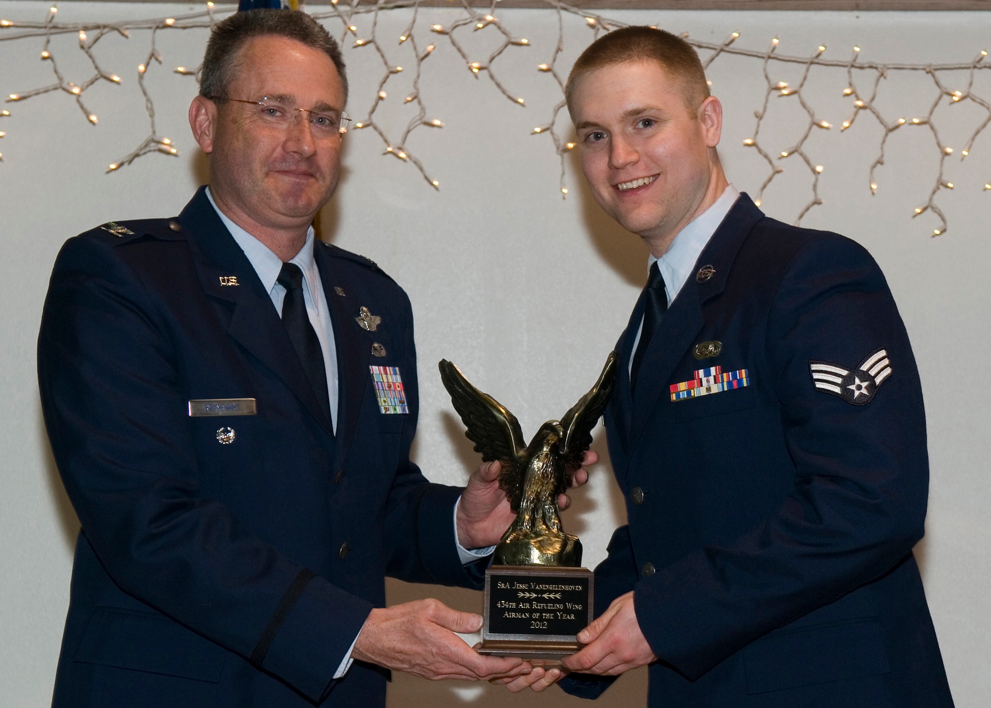 GRISSOM AIR RESERVE BASE, Ind. -- Senior Airman Jesse Vanengelehoven, 434th Logistics Readiness Squadron logistics plans technician, receives a 434th Air Refueling Wing Airman of the Year award from Col. Bryan Reinhart, 434th ARW vice commander, at an awards social near Grissom April 13. The event recognized the 434th ARW annual award winners for 2012. (U.S. Air Force photo/Senior Airman Andrew McLaughlin)  