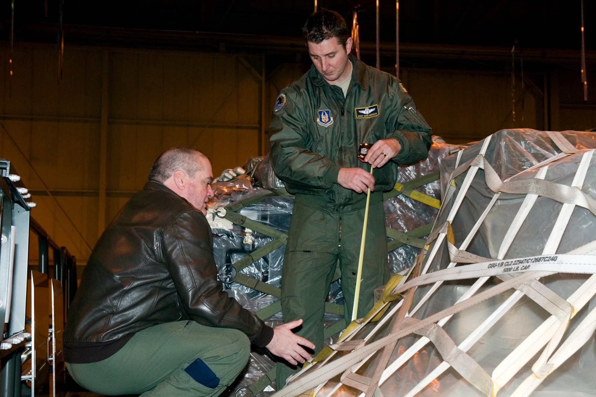 GRISSOM AIR RESERVE BASE, Ind. -- Master Sgt. Mike Morgan, 72nd Air Refueling Squadron boom operator, and Master Sgt. Tim Stibbe, 74th ARS assistant chief boom operator, measure pallets during cargo loading training here April 13. The purpose of the training was to keep 49th Aerial Port Flight Airmen proficient at transporting and loading cargo onto KC-135R Stratotankers and also allow aircrew an opportunity to see how the aerial port prepares the cargo beforehand. (U.S. Air Force photo/Senior Airman Andrew McLaughlin)