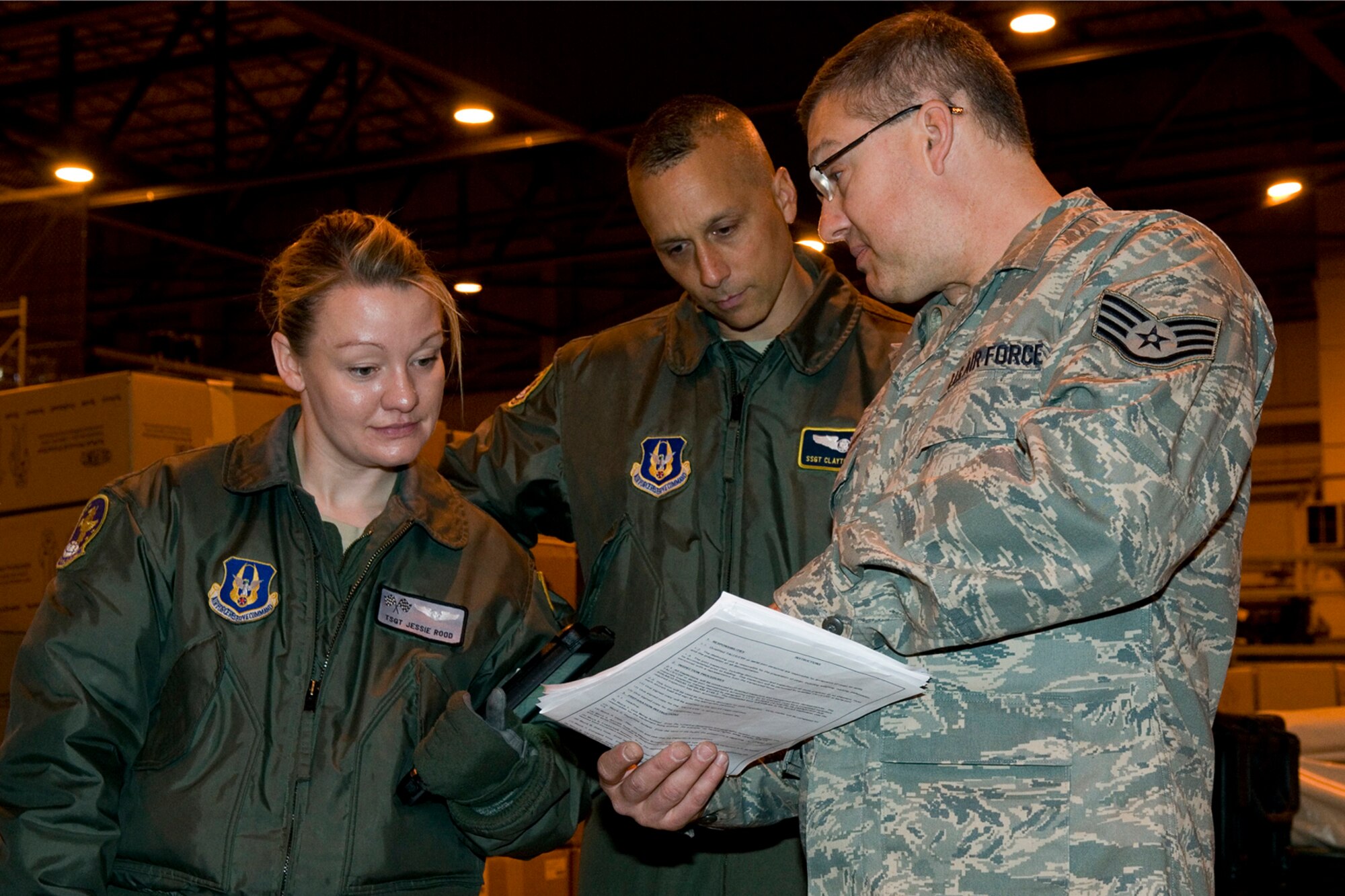 GRISSOM AIR RESERVE BASE, Ind. -- Staff Sgt. James Jackson, 49th Aerial Port Flight aerial port journeyman, briefs Tech. Sgt. Jessie Rood, 434th Operations Support Squadron boom operator, and Staff Sgt. Clayton Duncan, 72nd Air Refueling Squadron boom operator, during cargo loading training here April 13. The purpose of the training was to keep aerial port Airmen proficient at transporting and loading cargo onto KC-135R Stratotankers and also allow aircrew an opportunity to see how the 49th APF prepares the cargo beforehand. (U.S. Air Force photo/Senior Airman Andrew McLaughlin)