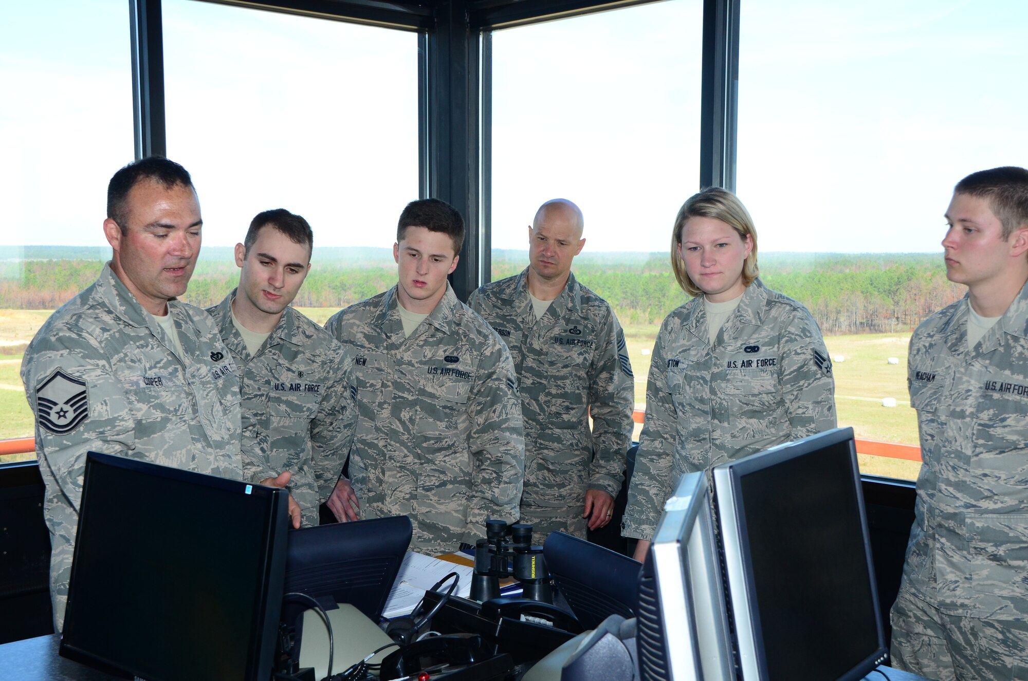A group of Miss. Air National Guardsmen receive instruction at Camp Shelby's Air to Ground Range control tower during the first-term Airmen retreat that took place on 6 April 2013.  The goal of the retreat was to give the junior Airmen the opportuity to see additional MSANG assets performing their mission and to allow them to gain career insight from senior enlisted personnel.