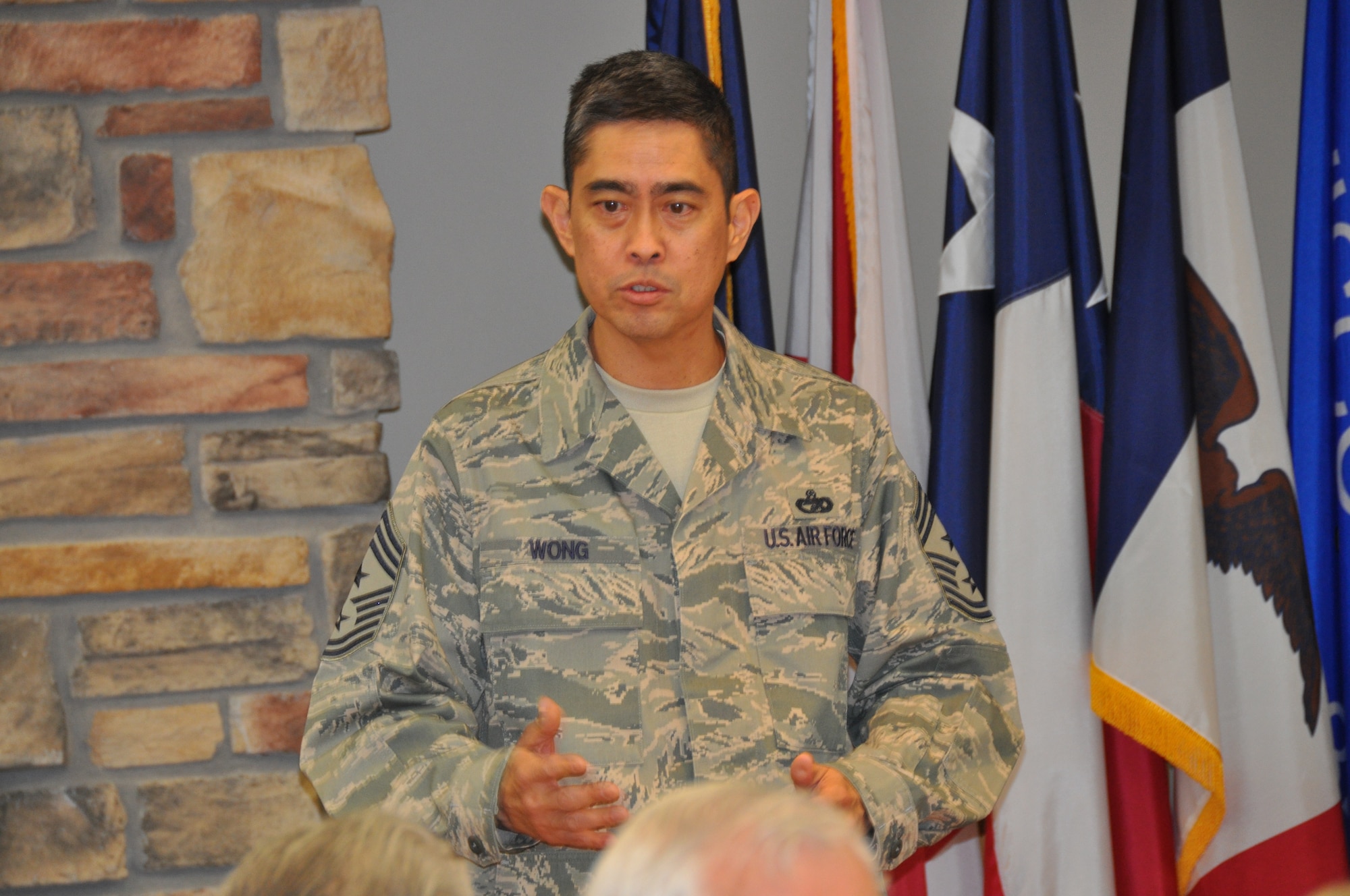 Chief Master Sgt. Brian C. L. Wong, Air Reserve Personnel Center command chief, addresses the audience during the Buckley Chiefs Group luncheon held at the headquarters ARPC building April 24, 2013, on Buckley Air Force Base, Colo. More than 40 top-ranking noncommissioned officers of the Armed Forces from Buckley AFB and the local area attended a unique meeting of the Colorado E-9er’s Association hosted by the Buckley Chiefs Group. (U.S. Air Force photo/Tech. Sgt. Rob Hazelett)