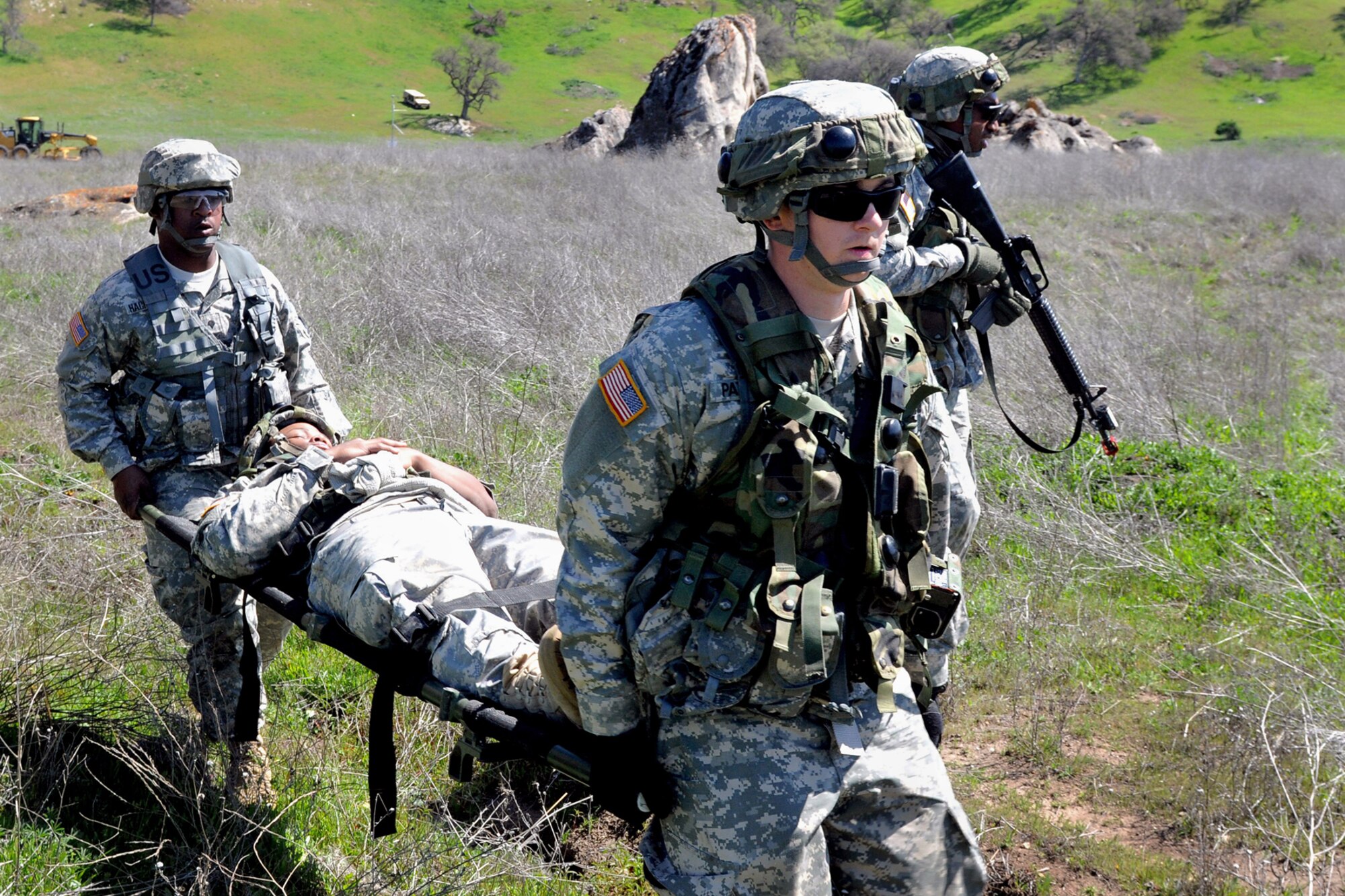 FORT HUNTER LIGGETT, Calif. -- Members of the 855th Quartermaster Company carry a soldier after a simulated injury during the 2013 Warrior Exercise March 16 at Fort Hunter Liggett, Calif. The convoy was part of a joint exercise with approximately 4,000 military participants that simulated nation-building necessities that could follow large-scale combat operations. (U.S. Army photos/Spc. Feleshia D. Dyer)