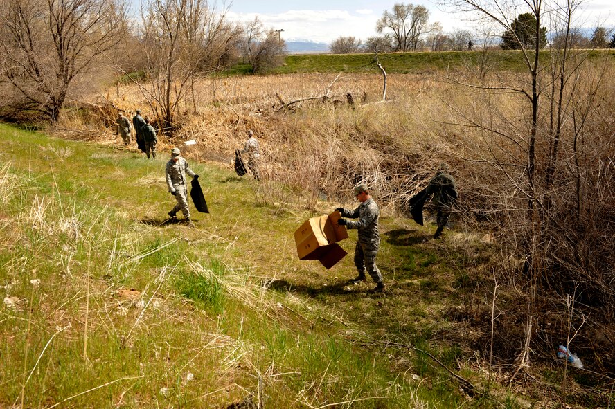 Airmen from the 2nd Combat Camera Squadron clean up the duck pond running trail area as part of an Earth Day event at Hill Air Force Base, Utah, April 22, 2013. Fifteen Airmen collected more than 10 bags of trash from the popular running trail to help clean up the base and help the environment. (U.S. Air Force photo/Staff Sgt. Renae Saylock)