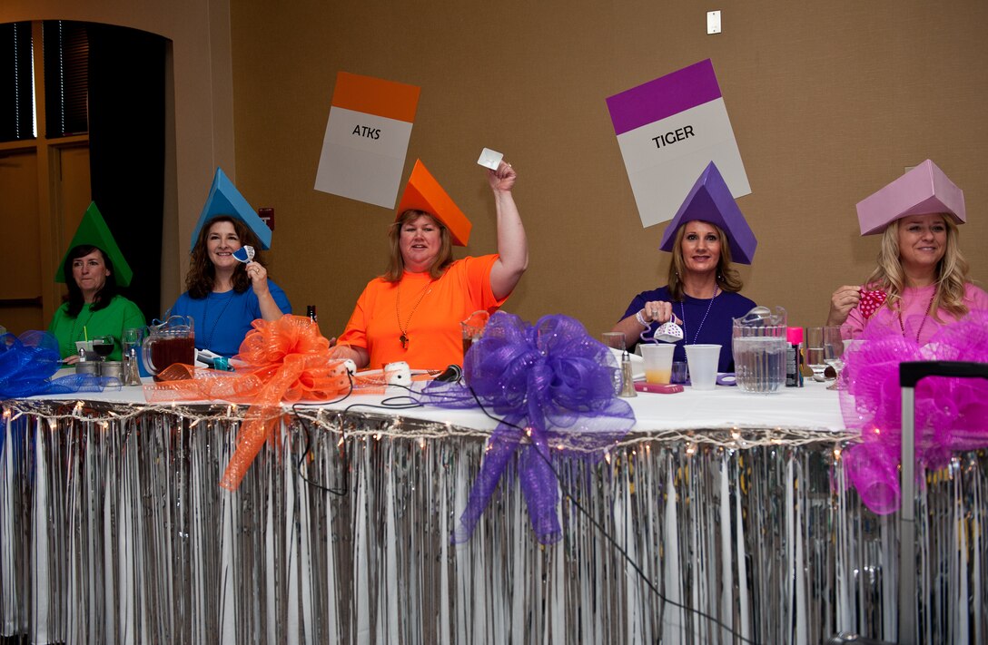 Senior leader spouses sit at the head table and ring their bells during toasts as part of the dining-in event held at the Dakota’s Club on Ellsworth Air Force Base, S.D., April 20, 2013. During the event, spouses spent time building new relationships and strengthening rapport within the Ellsworth community. (U.S. Air Force photo by Airman 1st Class Kate Thornton-Maurer/Released)