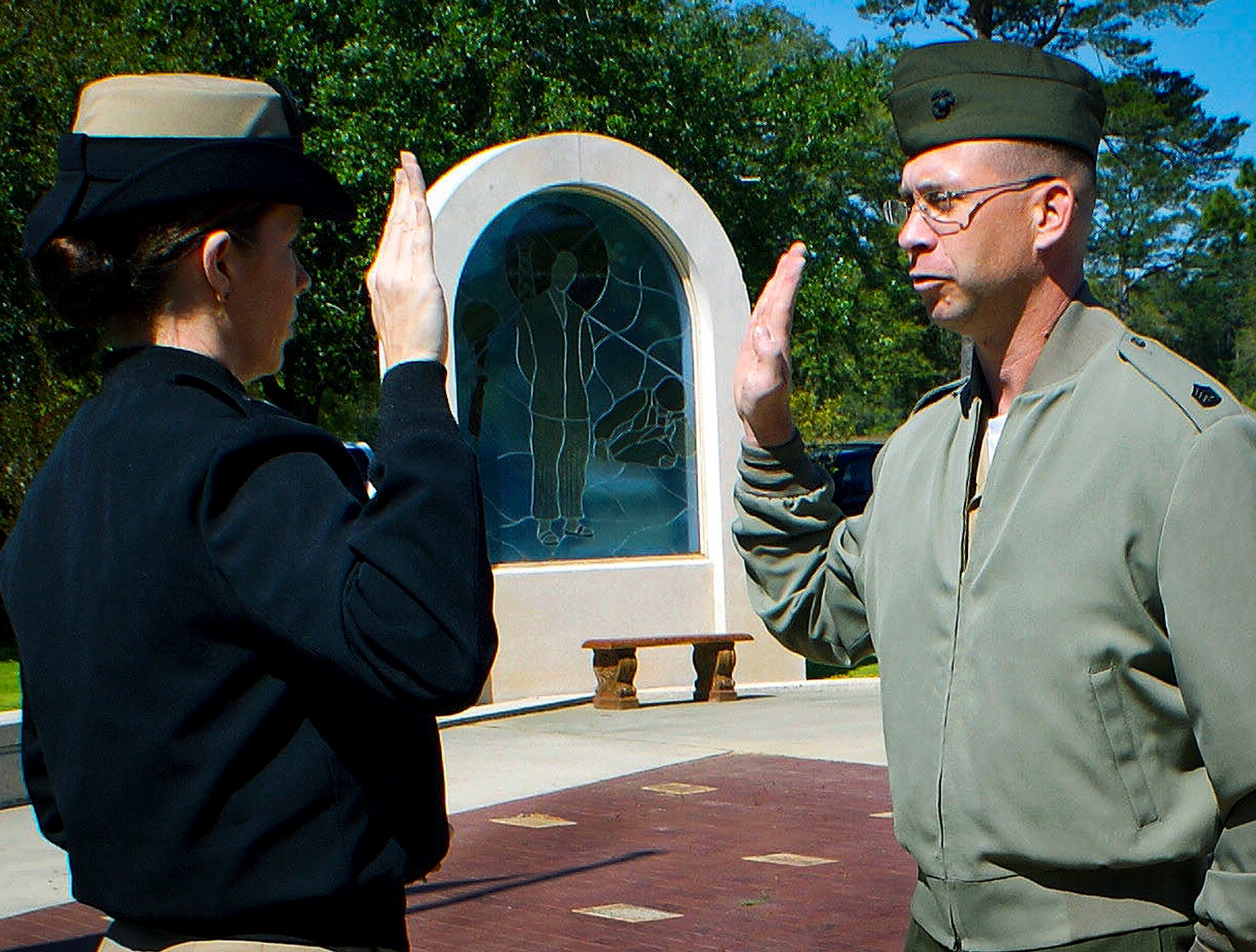 Gunnery Sgt. Markus Lill, the air frames division chief for Marine Fighter Attack Training Squadron 501 recites the oath of enlistment April 12 at the All Wars Memorial, at Eglin Air Force Base Fla.  Lt. j.g. Lisa Lill, who is also married to Lill, administered the oath for his fifth reenlistment.  (Courtesy photo) 