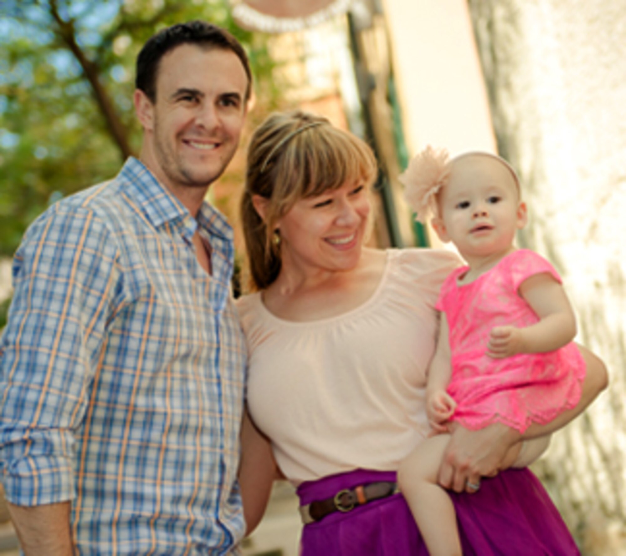 Danell Harrison, center, her husband, Capt. Michael Harrison, and their daughter, Bella. (Courtesy photo)