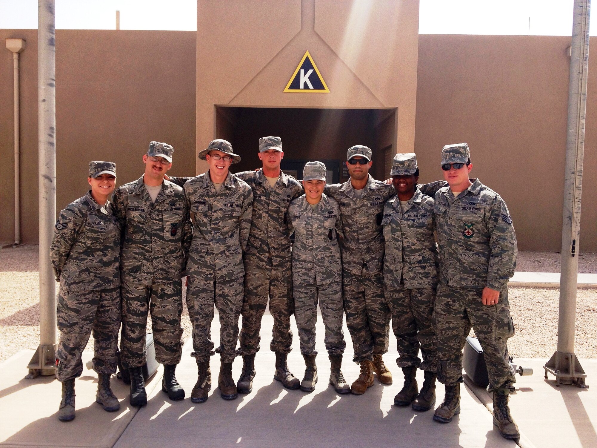 Airmen 1st Class Benjamin Hitzelberger, second from left, Charles Coushaine, third from left, and Vanessa Oros, center, pose for a group photo with five other Airmen who helped assist the victims of an off-base accident during a deployment in South West Asia. The three Airmen are deployed from Grand Forks Air Force Base, N.D. (Courtesy photo)