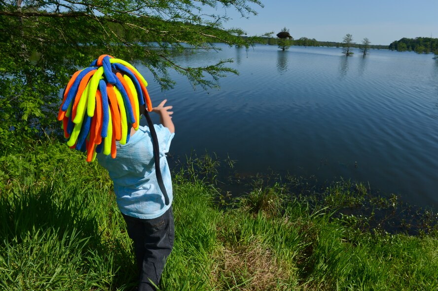 A child throws a fish he caught back into the water during the 8th annual Kids Fish event on Barksdale Air Force Base, La., April 20, 2013. After the fish were caught and measured, they were released back into the lake. (U.S. Air Force photo/Senior Airman Micaiah Anthony)