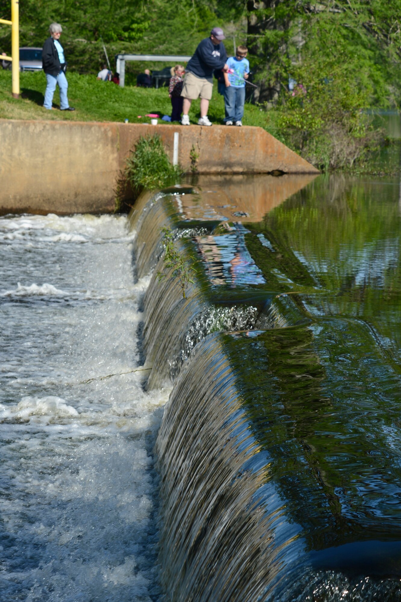 A family fishes during the 8th annual Kids Fish event on Barksdale Air Force Base, La., April 20, 2013. The event was held to increase recreational outings for military families with base access. Prizes were awarded to the children who caught the most, largest and smallest fish, along with the child with the coolest hat. (U.S. Air Force photo/Senior Airman Micaiah Anthony)
