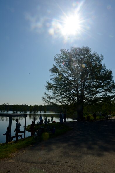 Parents fish with their children during the 8th annual Kids Fish event on Barksdale Air Force Base, La., April 20, 2013. Approximately 120 children participated in the event. Prizes were awarded to the children who caught the most, largest and smallest fish, along with the child with the coolest hat.  (U.S. Air Force photo/Senior Airman Micaiah Anthony)