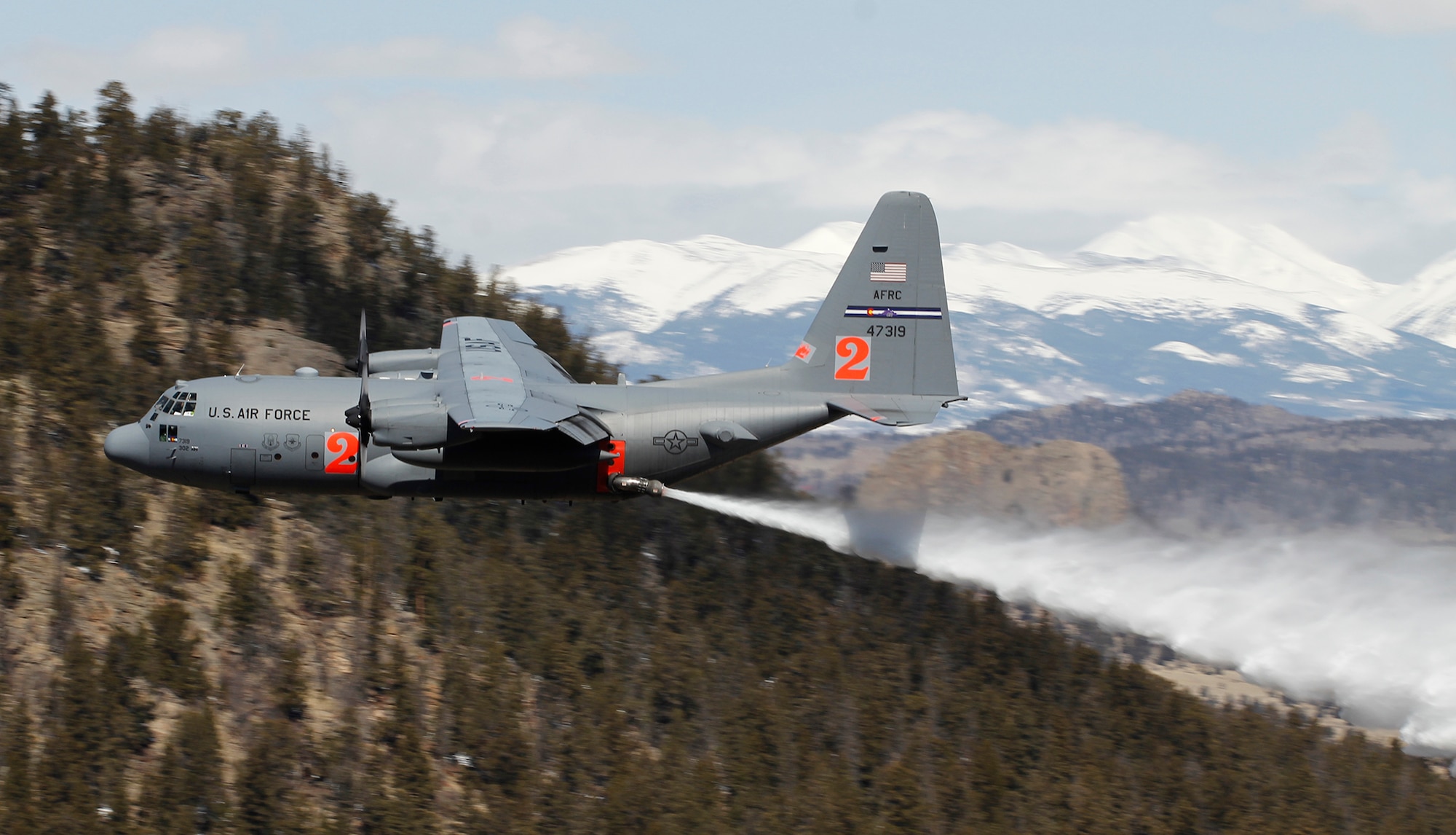 A Modular Airborne Fire Fighting System-equipped C-130 from the 302nd Airlift Wing drops a load of water April 22 near Fairplay, Colo. The Air Force Reserve Command’s 302nd AW held its annual MAFFS certification and re-certification for C-130 aircrews April 19-23. When it is determined MAFFS is needed, the National Interagency Fire Center through U.S. Northern Command requests the DOD's U.S. Air Force resources. These trained military personnel along with the MAFFS equipment are activated to supplement the civilian air tanker program during periods of high wildfire activity throughout the nation. In 2012 the 302nd AW MAFFS-equipped C-130s, aircrew and personnel supported fire suppression operations in 10 states, including drops on the Waldo Canyon fire near Colorado Springs. 2013 marks the 20th year the MAFFS mission has been flown by the Airmen and C-130s of the 302nd AW. (U.S. Air Force photo/Staff Sgt. Nathan Federico)