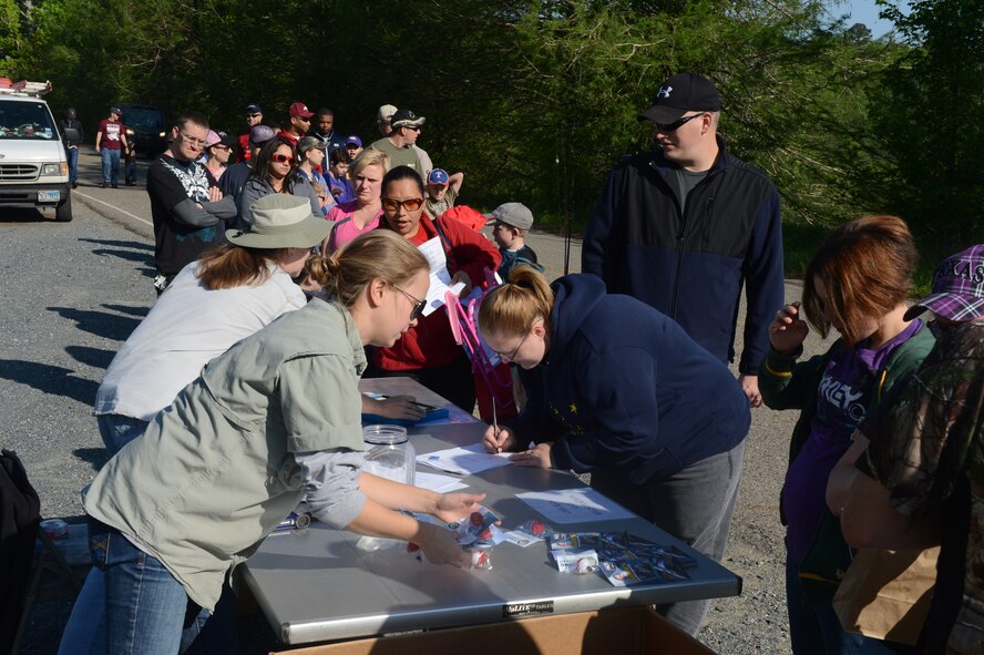 Catlin Cook and Corinna Bridges, 2nd Force Support Squadron Outdoor Recreation programmer and operations clerk, register participants for the 8th annual Kids Fish event on Barksdale Air Force Base, La., April 20, 2013. The event was held to increase recreational outings for military families with base access. The 120 children that participated in the event received a fishing starter kit along with other goodies. (U.S. Air Force photo/Senior Airman Micaiah Anthony)