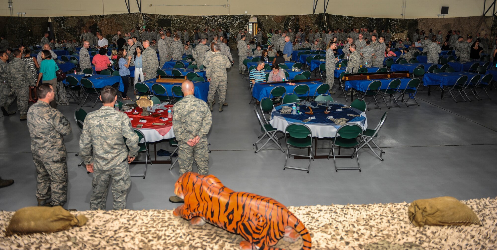 Airmen from various maintenance squadrons converse before the 2013 Maintenance Professional of the Year banquet begins at Moody Air Force Base, Ga., April 19, 2013. The banquet showcased the many hardworking Airmen who gave exceptional contributions to mission readiness throughout the year. (U.S. Air Force photo by Airman Alexis Grotz/ Released)