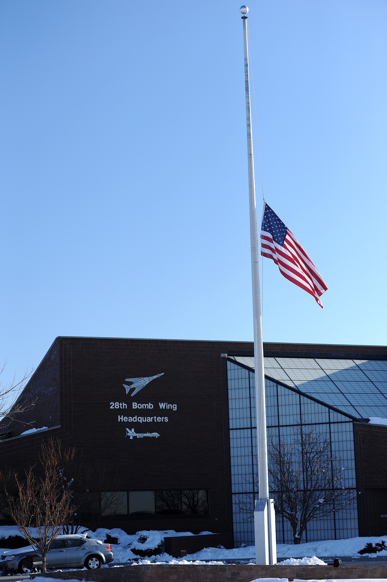 The flag stands at half-staff in honor of Maj. Gen. Joseph Brown IV at Ellsworth Air Force Base, S.D., April 23, 2013. Brown and his wife, Sue S. Brown, were killed April 19 when the Cessna 210 he was piloting crashed in Williamsburg, Va. During his career Brown served in a variety of positions, including commander of the 28th Operations Group and 28th Bomb Wing at Ellsworth. (U.S. Air Force photo by Airman 1st Class Hrair H. Palyan/Released)