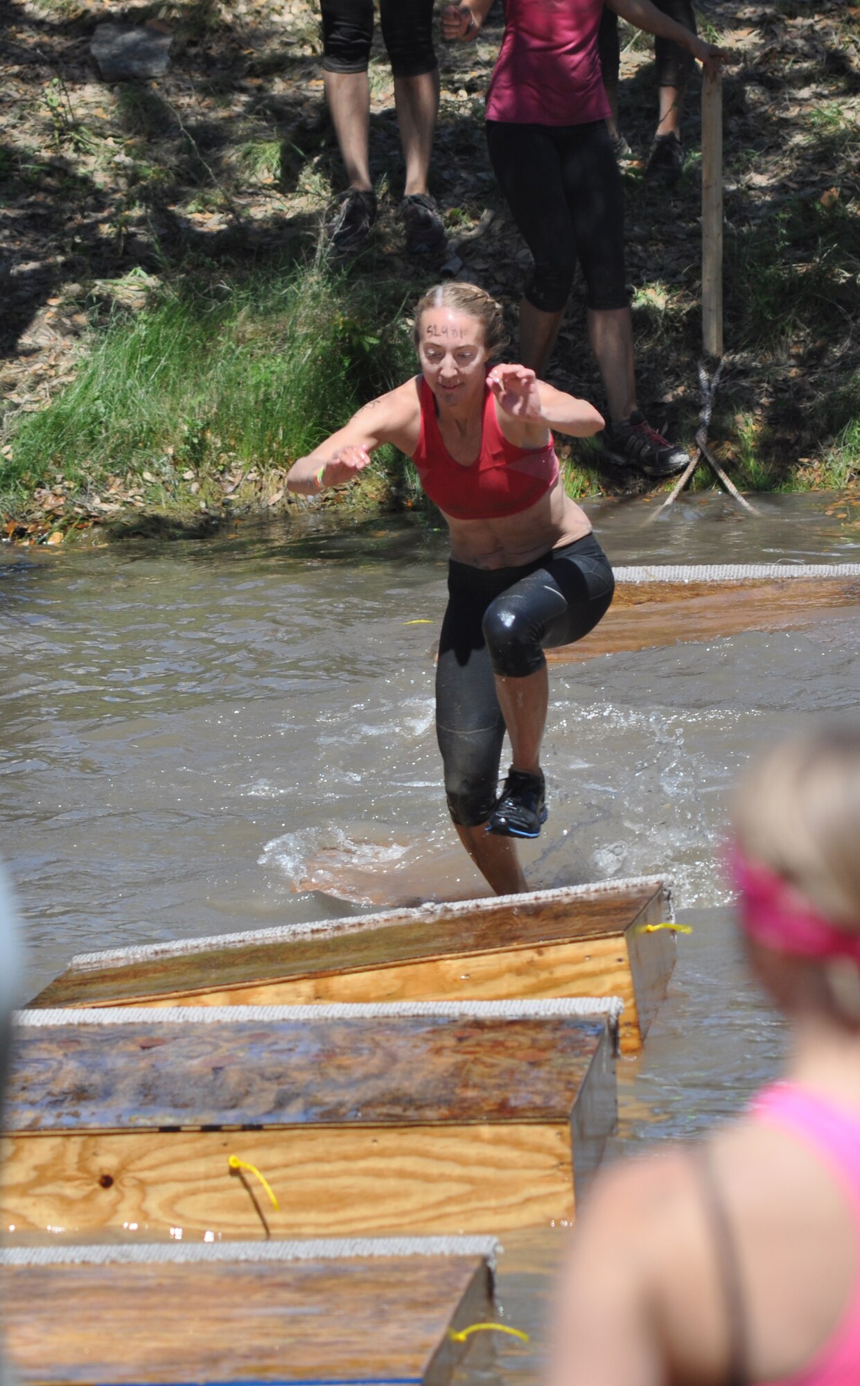 Two 44th Fighter Group members and one active duty 7th Fighter Squadron pilot's spouse from Holloman AFB, New Mexico, competed in the “Tough Mudder” competition in Austin, Texas, Saturday, April 20. Here one team members is traversing a water obstacle but they all ran more than 10 miles facing a total of 22 military obstacles! The Tough Mudder competition is a strong supporter of the Wounded Warrior Foundation. The 44th FG, at Holloman AFB, New Mexico, is a geographically separated unit of the 301st Fighter Wing located at Naval Air Station Fort Worth Joint Reserve Base, Texas. (Courtesy photo)