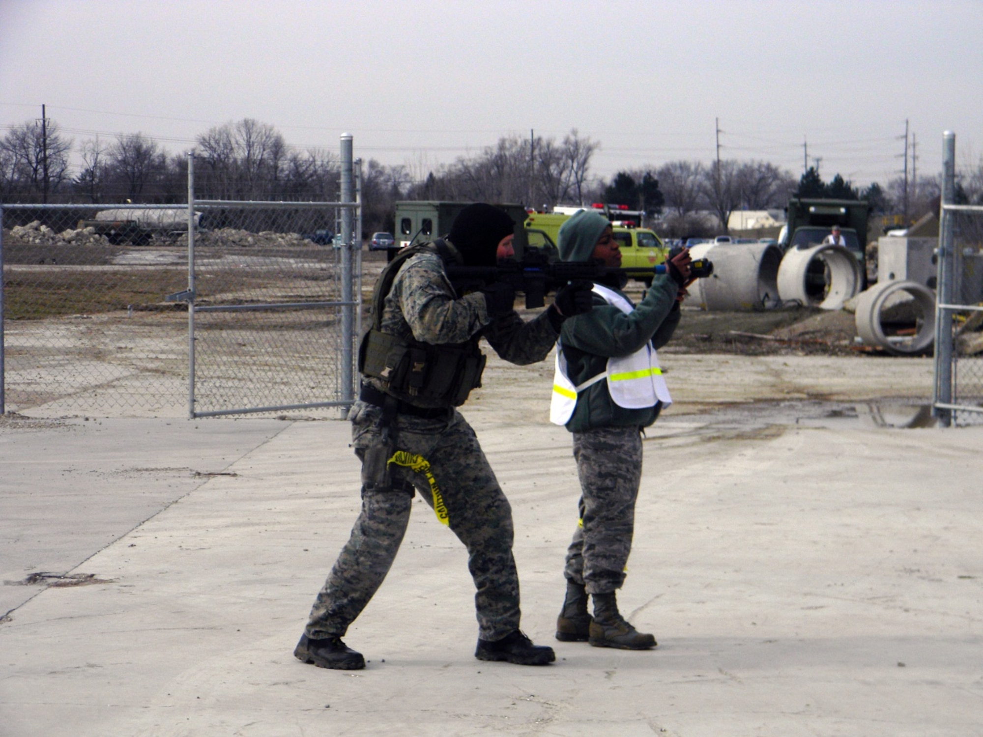 Sniper 1 covers an exit while 2dLt Sheri Lamb of AFRL, uses a FLIR (Forward Looking Infrared) camera to push imagery to the sensor grid at the request of the Incident Commander.