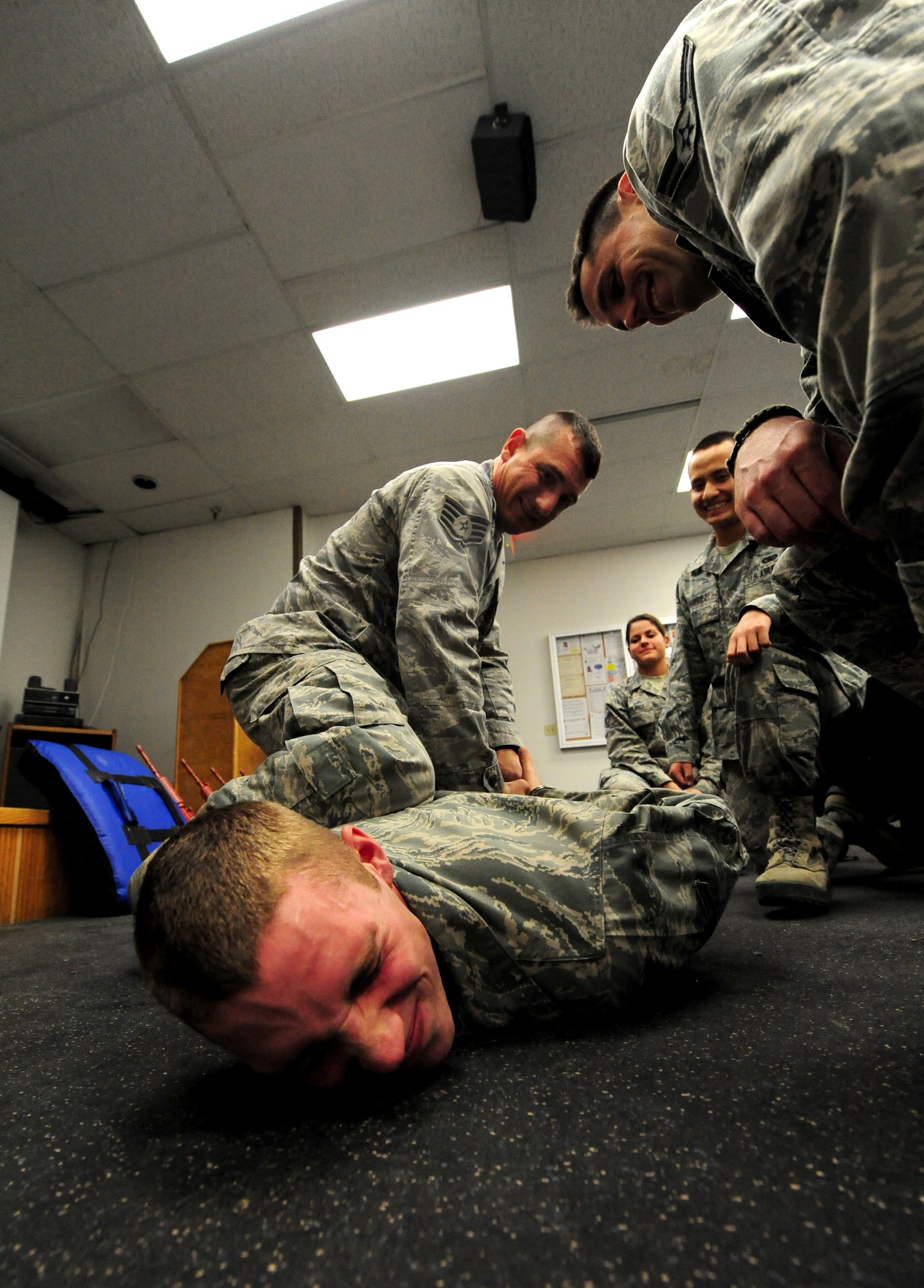 Staff Sgt. Michael Krivitza, 509th Security Forces Squadron Phase I trainer, demonstrates the proper way to detain a suspect to new security forces Airmen at Whiteman Air Force Base, Mo., April 16, 2013. Hands-on training exercises like this one give Airmen the knowledge and experience they need to respond to real-world scenarios. (U.S. Air Force photo by Staff Sgt. Nick Wilson/Released)